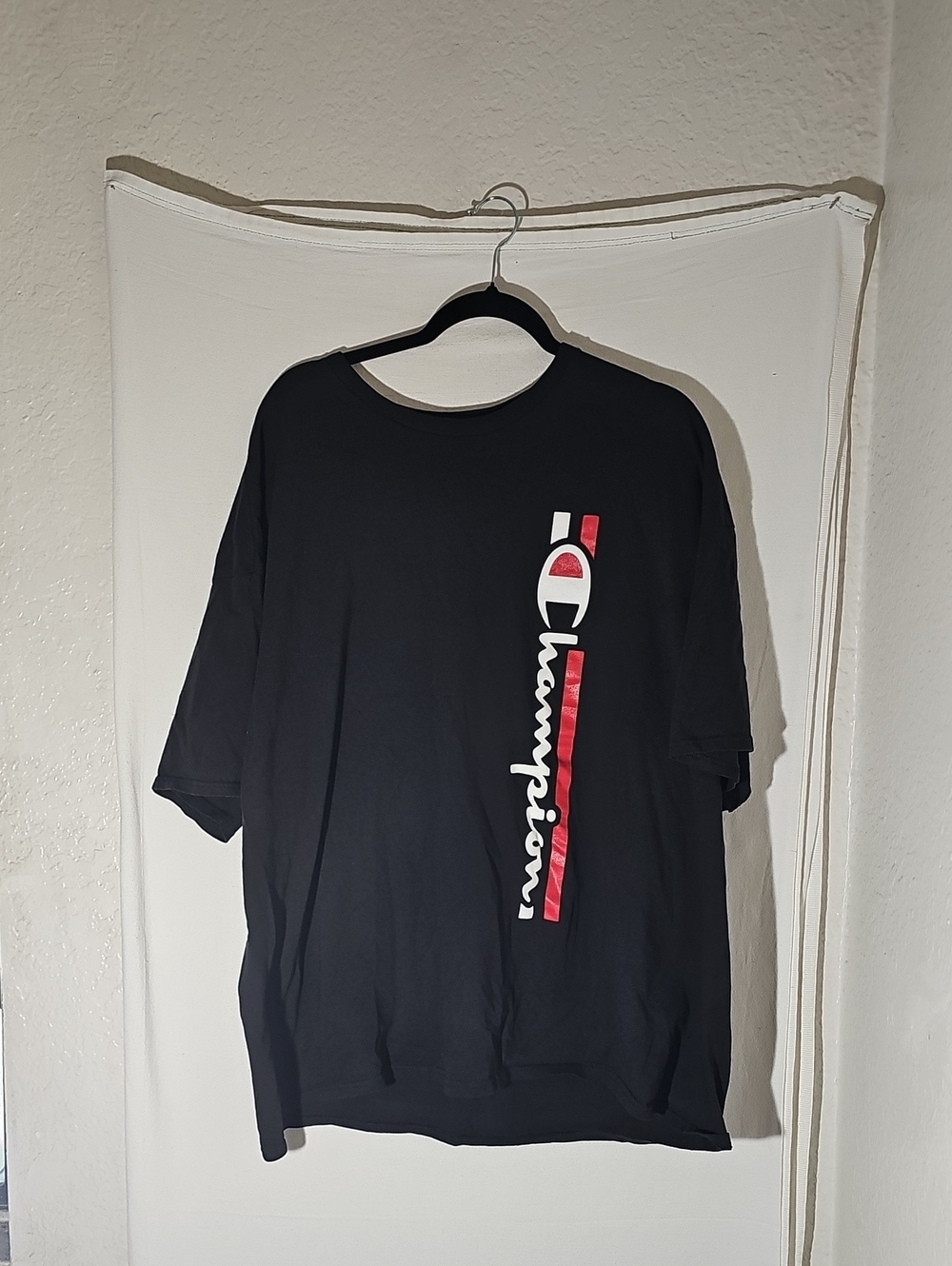 Champion Menโs Black Short Sleeve Tee with Vertical Red & White Logo